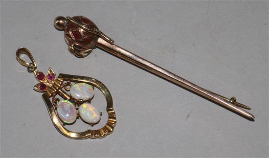 An early 20th century 9ct gold and jasper set sword brooch and a 14ct gold, white opal and ruby pendant.